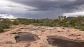 Ephemeral pools wait for rain as lightning strikes in the distance