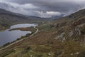 Epic aerial flying drone landscape image of Snowdon Massif viewed from above Llynau Mymber during Autumn sunset with dramatic sky Royalty Free Stock Photo