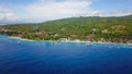 Epic aerial top down of crystal clear coral reefs under wooden pier on Gili Meno Island during sunshine Royalty Free Stock Photo