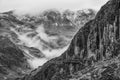 Epic  black and white Winter landscape image of view from Side Pike towards Langdale pikes with low level clouds on mountain tops Royalty Free Stock Photo