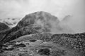 Epic black and white Winter landscape image of view from Side Pike towards Langdale pikes with low level clouds on mountain tops Royalty Free Stock Photo