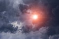 Epic cumulus storm dark grey clouds background with sun and sunlight