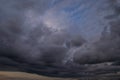 Epic Dramatic Storm sky, dark grey violet clouds against blue sky background texture Royalty Free Stock Photo