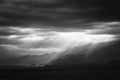 Epic, dramatic sunrays seeping through the clouds over the Andes Mountains in Mendoza, Argentina, on a dark, cloudy day. Royalty Free Stock Photo
