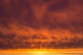 Epic Dramatic sunrise, sunset orange yellow red clouds with sun and sunlight on storm sky background texture Royalty Free Stock Photo