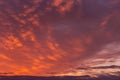 Epic dramatic sunrise, sunset red orange pink sky with mammatus clouds background texture Royalty Free Stock Photo