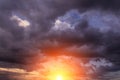 Epic dramatic sunset, sunrise on storm sky with dark clouds, orange yellow sun Royalty Free Stock Photo
