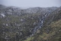 Epic landscape image of hikers going up slopes of Y-Garn in Autumn in Snowdonia National Park Royalty Free Stock Photo