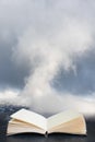 Epic landscape image of Skiddaw snow capped mountain range in Lake District in Winter with low level cloud around peaks viewed Royalty Free Stock Photo