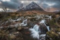 Epic majestic Winter sunset landscape of Stob Dearg Buachaille Etive Mor iconic peak in Scottish Highlands with famous River Etive