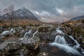 Epic majestic Winter sunset landscape of Stob Dearg Buachaille Etive Mor iconic peak in Scottish Highlands with famous River Etive