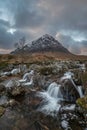 Epic majestic Winter sunset landscape of Stob Dearg Buachaille Etive Mor iconic peak in Scottish Highlands with famous River Etive