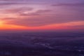 Epic red sunset over the rocks and stones of Ural mountains covered with snowy pines Royalty Free Stock Photo