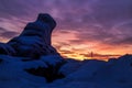 Epic red sunset over the rocks and stones of Ural mountains covered with snowy pines. Royalty Free Stock Photo