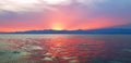Red Sunset on Lake Kivu, Rwanda. Soft Clouds, waves and the glow of the sun, over the horizon. Royalty Free Stock Photo