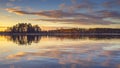 Epic red sunset sky above the lake and forest. Dramatic cloudscape. Symmetry reflections on the water, natural mirror Royalty Free Stock Photo