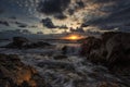 Epic seascape shot at sunrise with dynamic sky and pretty rocks Royalty Free Stock Photo