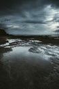 Epic seascape landscape with clouds and flood ground. Black and stormy clouds weather in background. Dramatic skyscape with black Royalty Free Stock Photo