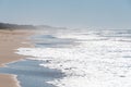 Epic seascape view with long beach with sand shore and mild glistening waves