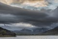 Epic stunning Autumn landscape image of Snowdon Massif viewed from shores of Llynnau Mymbyr at sunset with dramatic dark sky and Royalty Free Stock Photo
