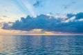 Epic sunburst and colorful skies as the suns sets off the coast of tropical Caribbean island. Royalty Free Stock Photo