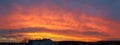 Epic sunset in red, orange ,blue, violet, purple, crimson colors. Long panorama. Royalty Free Stock Photo