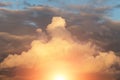 Epic sunset storm sky with sun and yellow orange sunlight. Big fluffy cumulus clouds on blue sky background texture Royalty Free Stock Photo