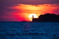 Epic sunset view with lighthouse and saiboat