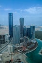 Epic top view shot of Al Reem island towers and landscape with a cloudy blue sky