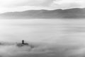 An epic view of St.Francis church in Assisi town Umbria above a sea of fog at dawn Royalty Free Stock Photo