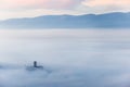 An epic view of St.Francis church in Assisi town Umbria above a sea of fog at dawn Royalty Free Stock Photo