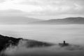 An epic view of St.Francis church in Assisi town Umbria above a sea of fog at dawn Royalty Free Stock Photo