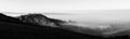 A panoramic, epic view of St.Francis church in Assisi town Umbria above a sea of fog at dawn