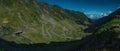 Epic winding road on Transfagarasan pass in Romania in summer time, with twisty road rising up. Road crossing Fagaras mountain