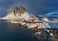 Epic winter seascape from Norway shot at sunrise with dynamic sky and pretty mountain