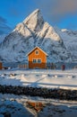 Epic winter seascape from Norway shot at sunrise with dynamic sky and pretty mountain