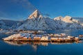 Epic winter seascape from Norway shot at sunrise with dynamic sky and pretty mountain