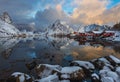 Epic winter seascape from Norway shot at sunrise with dynamic sky and pretty mountain