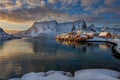 Epic winter seascape from Norway shot at sunrise with dynamic sky and pretty mountain