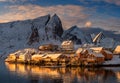 Epic winter seascape from Norway shot at sunrise with dynamic sky and pretty mountain