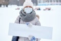 Epidemic of the Chinese coronavirus. A woman in a protective mask with a board