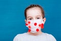 Epidemic covid-19. A girl in a medical mask encircled by a coronavirus on a blue background. Infecting children Royalty Free Stock Photo