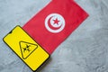 Epidemiological situation in the country Tunisia. Flag and smartphone with news and a biohazard symbol.