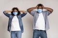 Epidemy Panic. Frightened Couple In Protective Masks Holding Head With Hands Royalty Free Stock Photo