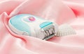 Epilator on the pink silk