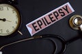 Epilepsy on the print paper with Healthcare Concept Inspiration. alarm clock, Black stethoscope. Royalty Free Stock Photo