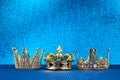 Epiphany Day or Dia de Reyes Magos concept. Three gold crowns on blue sparkling background