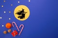Epiphany day tradition.Witch Befana flying on broomstick on dark blue background. Candy, nuts, gifts
