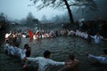 Epiphany Traditions - Jordan. Men dance in the icy waters of the river Tunja on January 6, 2011, Kalofer, Bulgaria