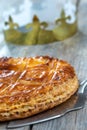 Epiphany Twelfth Night cake french galette des rois made of puff pastry, with the charm inside, open crown leaning